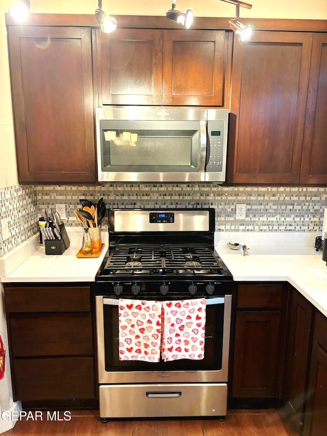 kitchen with light countertops, appliances with stainless steel finishes, and decorative backsplash