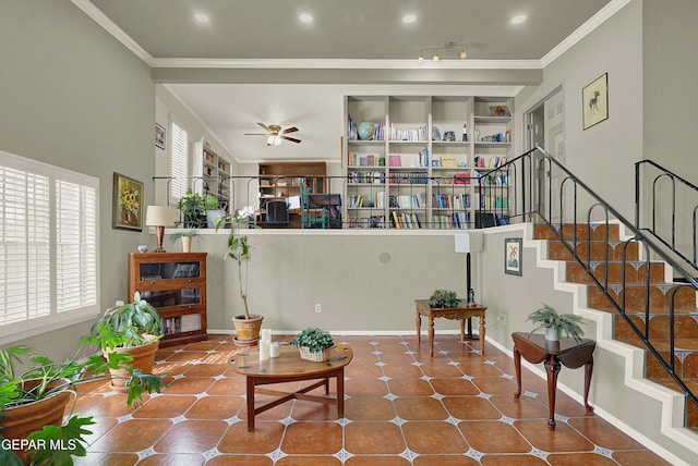 living area featuring stairs, built in shelves, baseboards, and crown molding