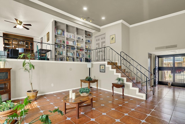 interior space with crown molding, visible vents, ceiling fan, tile patterned flooring, and baseboards