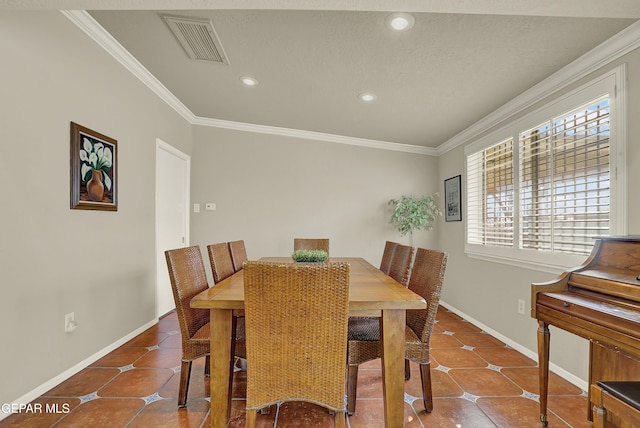 dining room with visible vents, ornamental molding, and tile patterned floors