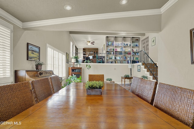 dining room featuring ornamental molding, ceiling fan, built in features, and stairs