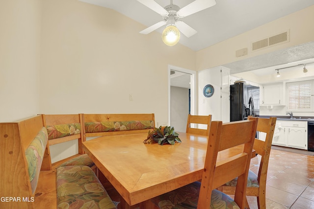 dining area with light tile patterned floors, visible vents, and a ceiling fan