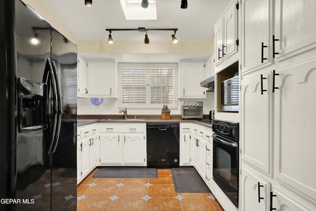 kitchen featuring light tile patterned floors, dark countertops, under cabinet range hood, black appliances, and a sink