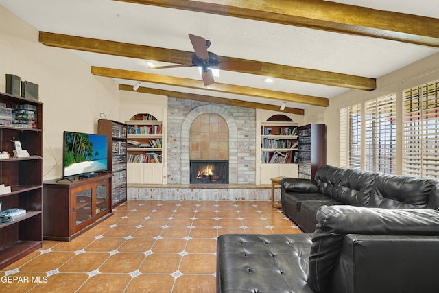 living room with beamed ceiling, a fireplace, tile patterned flooring, and built in features