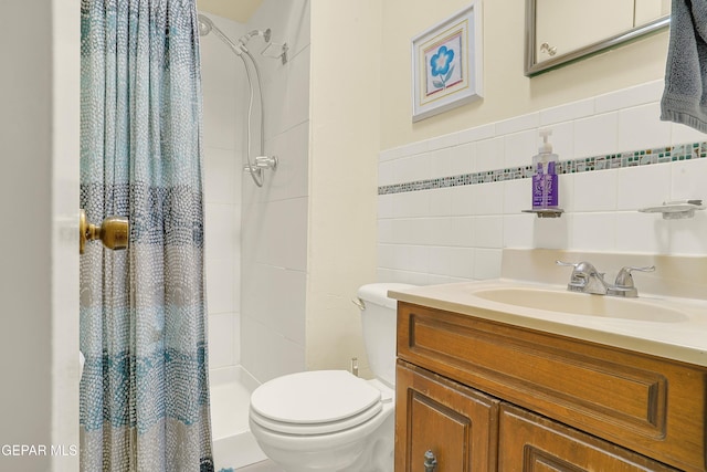 bathroom featuring toilet, tiled shower, vanity, and tile walls