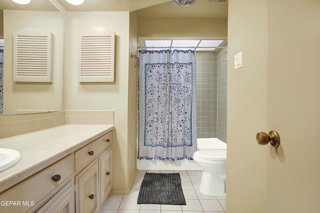 bathroom featuring vanity, tile patterned flooring, and toilet