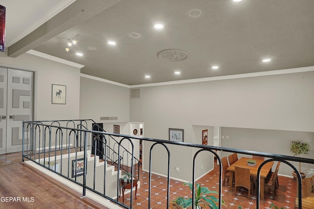 hallway with visible vents, ornamental molding, and recessed lighting