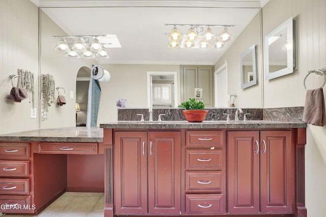 full bath featuring ornamental molding, tile patterned floors, a sink, and double vanity