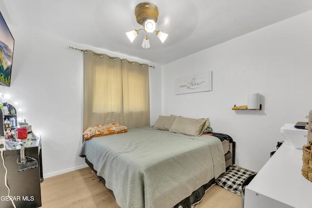 bedroom with light wood-type flooring and baseboards