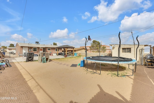 exterior space with a gazebo and a trampoline