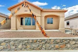 rear view of property with stucco siding