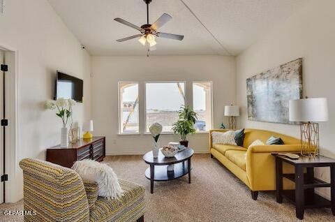 carpeted living room with vaulted ceiling and ceiling fan