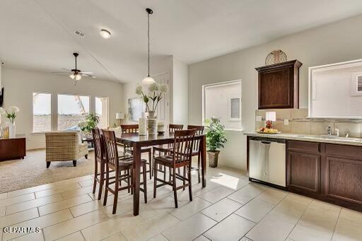 dining room with ceiling fan and visible vents