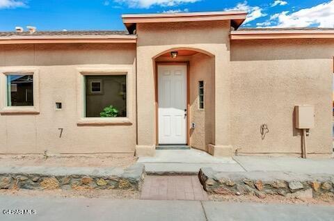 property entrance with stucco siding