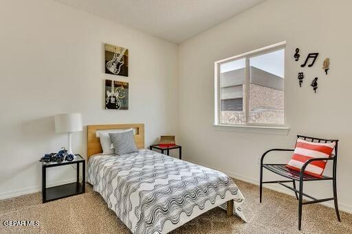 bedroom featuring carpet and baseboards