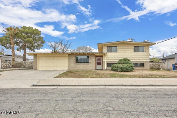 split level home with a garage and concrete driveway