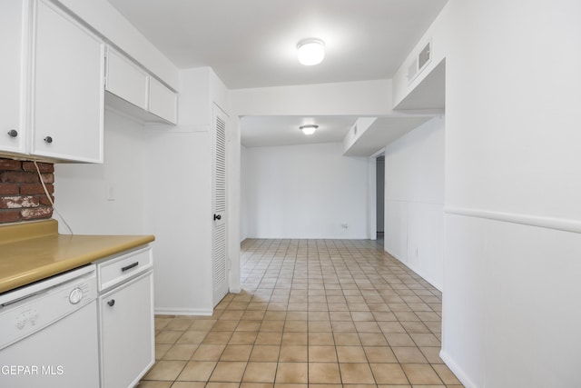 kitchen featuring light tile patterned floors, white dishwasher, visible vents, white cabinetry, and light countertops