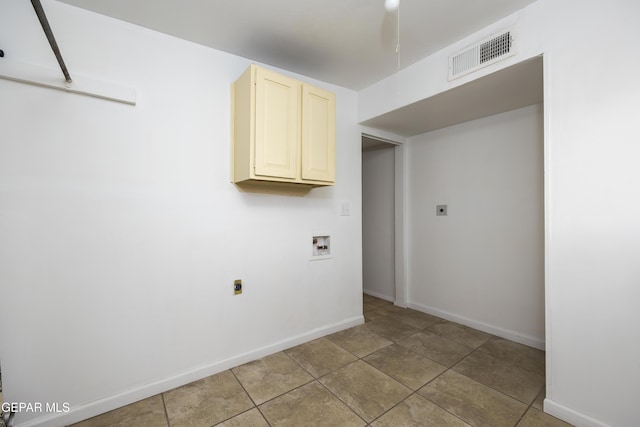 clothes washing area featuring washer hookup, cabinet space, visible vents, and electric dryer hookup