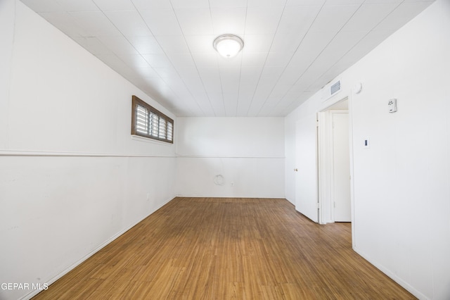 empty room with visible vents and wood finished floors