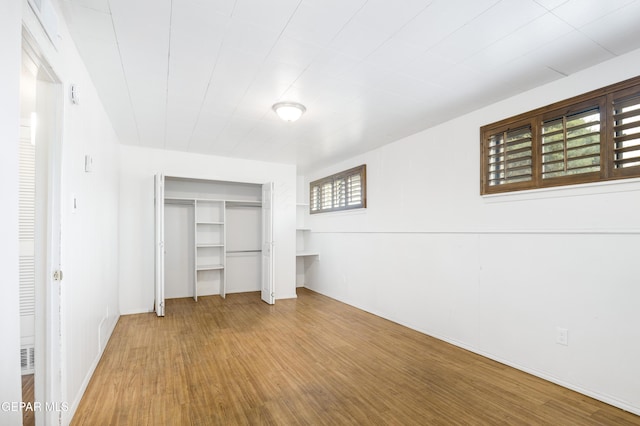 unfurnished bedroom with a closet and wood finished floors