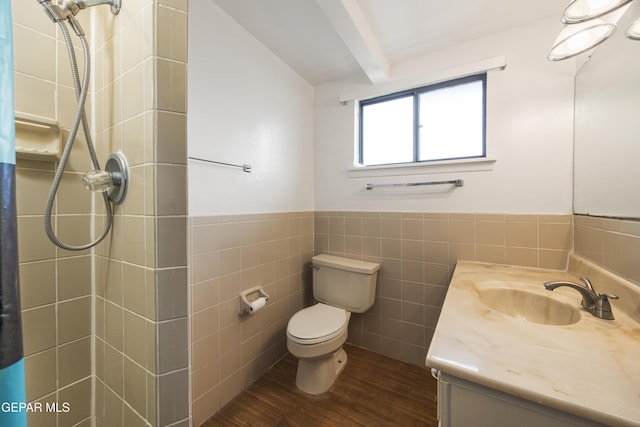 full bath with tiled shower, tile walls, toilet, and wood finished floors