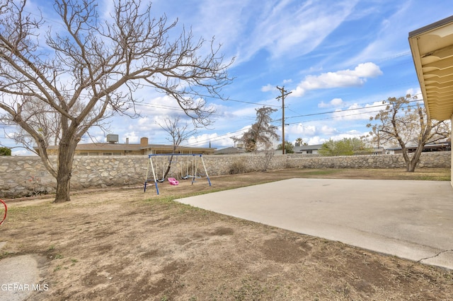 view of yard featuring a patio, a playground, and a fenced backyard