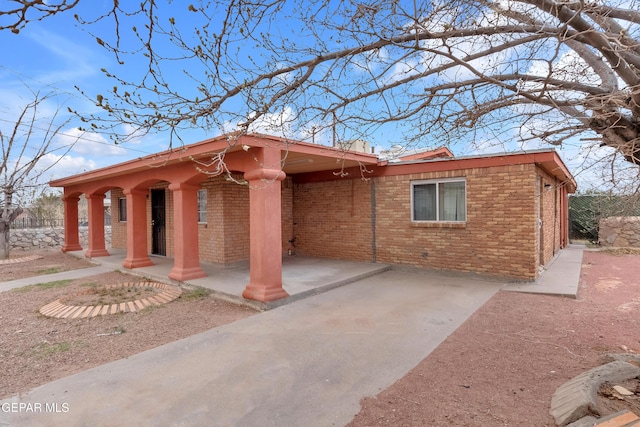 view of front of home with brick siding and fence