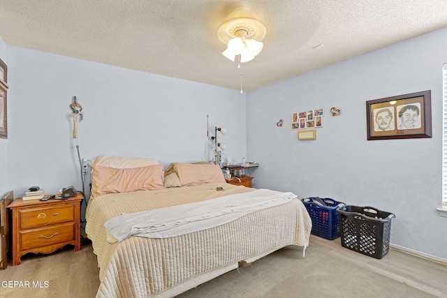 bedroom with a textured ceiling and ceiling fan