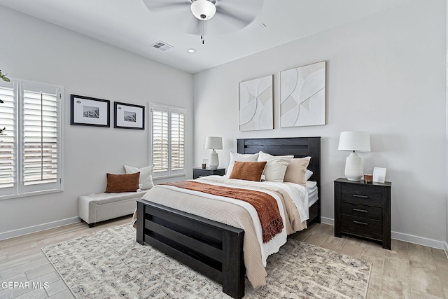 bedroom with light wood-style floors, baseboards, and visible vents