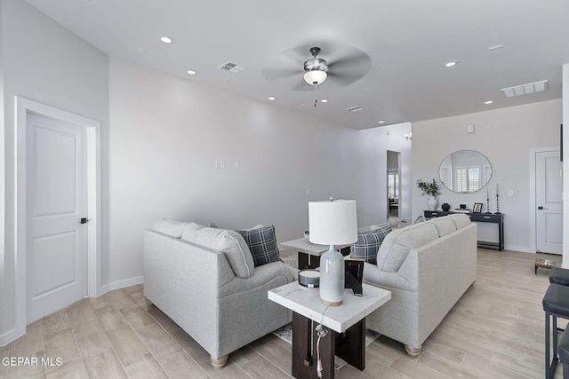 living area featuring ceiling fan, visible vents, and recessed lighting