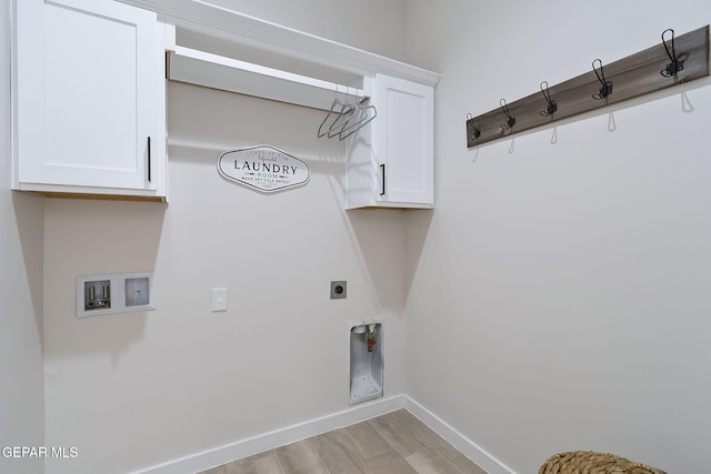 clothes washing area with cabinet space, baseboards, light wood-style flooring, hookup for a washing machine, and electric dryer hookup