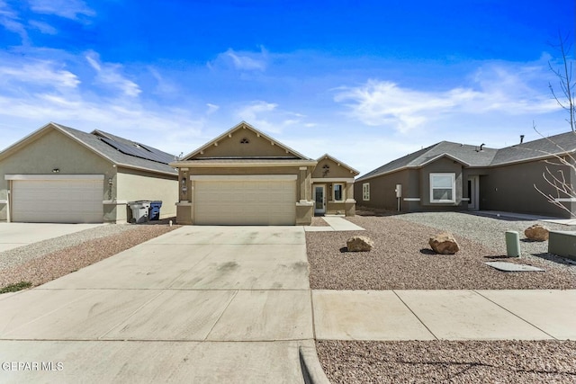 view of front of property with stucco siding, a garage, and concrete driveway