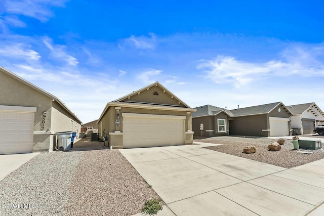 view of front of home with stucco siding, concrete driveway, and a garage