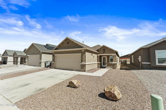 view of front of home featuring concrete driveway, an attached garage, and stucco siding