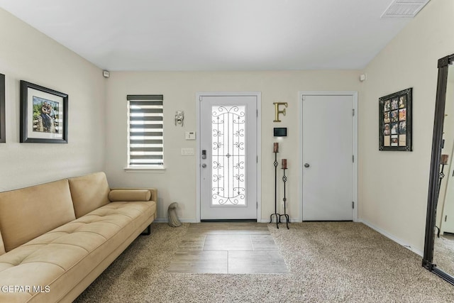 foyer entrance with visible vents and baseboards