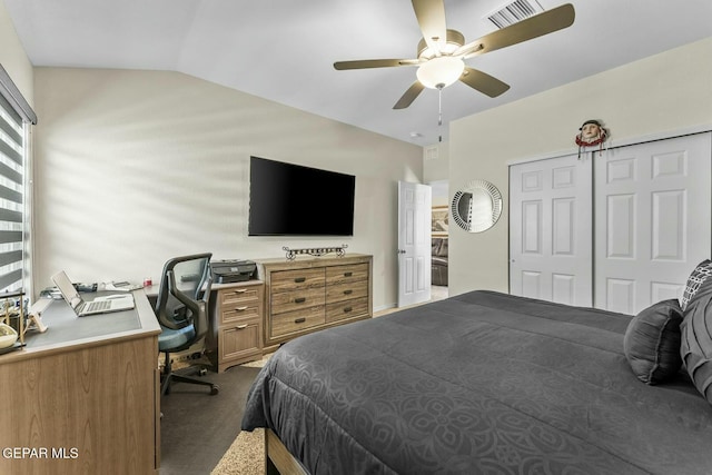 bedroom with a ceiling fan, visible vents, lofted ceiling, a closet, and dark colored carpet