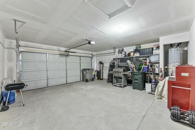 garage featuring water heater and a garage door opener