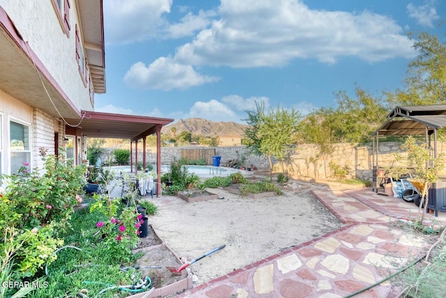 view of patio with a fenced backyard and a mountain view