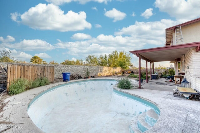 view of pool featuring a fenced in pool, a fenced backyard, and a patio