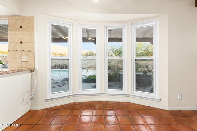 doorway featuring baseboards