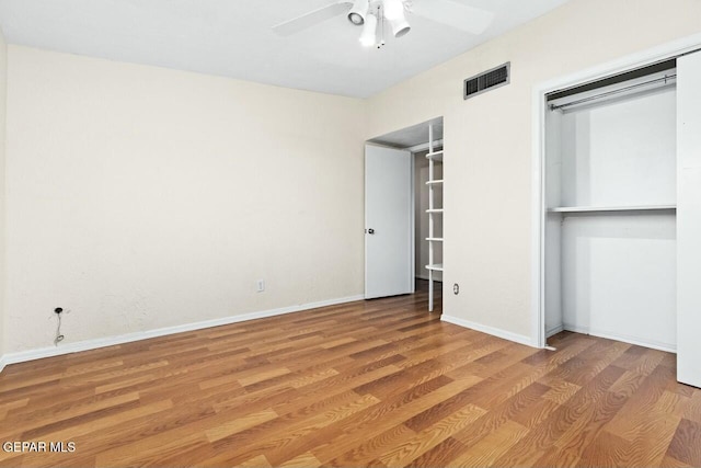 unfurnished bedroom featuring ceiling fan, light wood-type flooring, visible vents, and baseboards