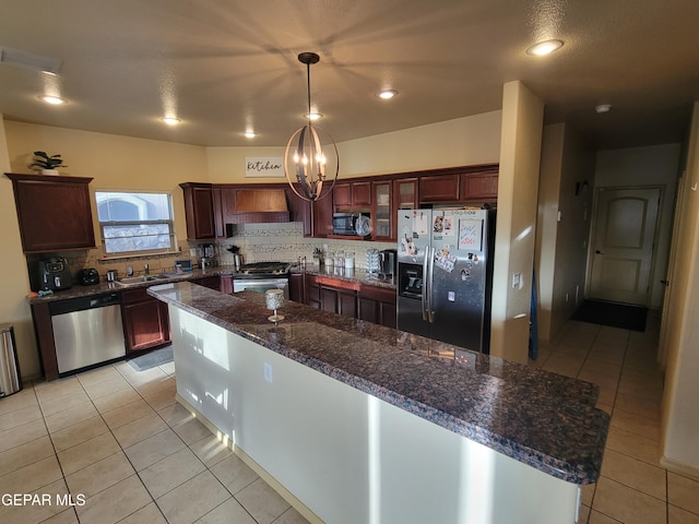 kitchen featuring light tile patterned floors, custom range hood, stainless steel appliances, and decorative backsplash