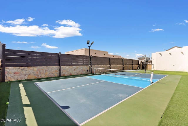 view of tennis court with fence