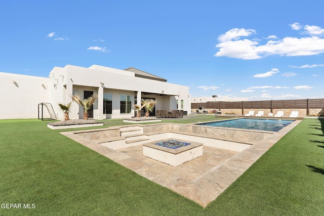 view of pool with a fenced in pool, a fire pit, fence, a lawn, and a patio area