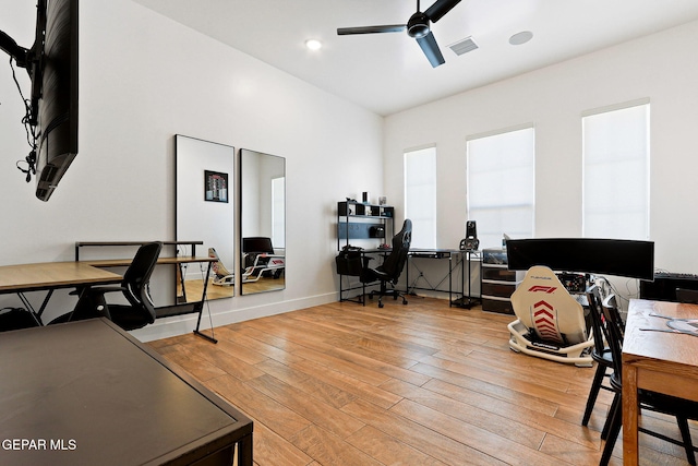 office area with visible vents, baseboards, a ceiling fan, and hardwood / wood-style floors