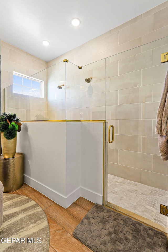 full bath with recessed lighting, baseboards, and a stall shower