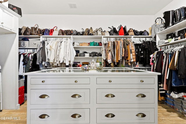 walk in closet with visible vents and light wood-style floors