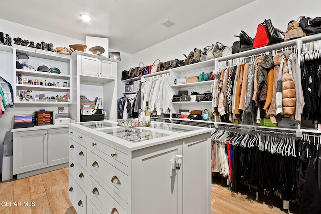 spacious closet featuring visible vents and light wood-style floors