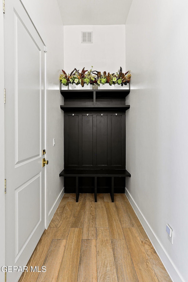 details featuring visible vents, baseboards, and wood finished floors