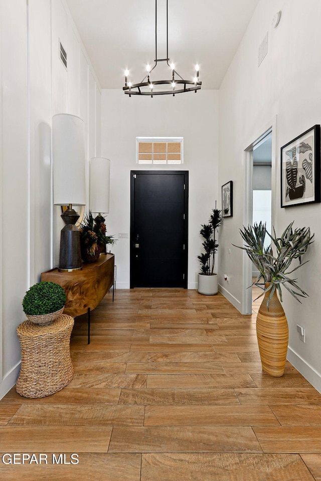 entryway featuring visible vents, light wood-type flooring, and baseboards